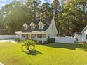 House's exterior features a large yard, and a white fence surrounds the property at 118 Sly Fox Trail, Myrtle Beach, SC 29588