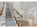 Elegant staircase with a runner and light-colored wood at 118 Sly Fox Trail, Myrtle Beach, SC 29588