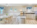 Bright kitchen featuring white cabinetry, granite countertops, and a charming breakfast nook at 328 S Waccamaw Dr., Garden City Beach, SC 29576