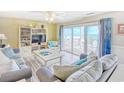 Cozy living room with ocean view, sliding glass doors, and comfortable seating area at 328 S Waccamaw Dr., Garden City Beach, SC 29576