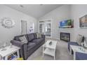 Comfortable living room featuring vaulted ceiling, a fireplace, and stylish furnishings at 9772 Leyland Dr. # 9772-9, Myrtle Beach, SC 29572