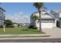 A light gray two-story home overlooking the water and other homes in the community at 981 Crystal Waterway Dr., Myrtle Beach, SC 29579