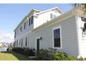A light gray two-story home with black door and windows, nicely landscaped and pond view at 981 Crystal Waterway Dr., Myrtle Beach, SC 29579