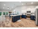 Spacious kitchen with two-toned cabinets, island, and stainless steel appliances at 306 Southgate Ct., Pawleys Island, SC 29585