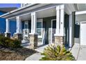 Front porch with stone pillars and a welcome sign at 3149 Bramble Glen Dr., Myrtle Beach, SC 29579