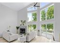 Bright living room boasting soaring ceilings, large windows, fireplace, and access to the outdoor deck at 5800 Creekside Dr., Myrtle Beach, SC 29588