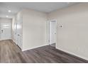 Inviting home entryway with a coat closet, neutral walls, and modern, wood-look flooring at 3034 Deerberry Place, Longs, SC 29568