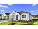 Stylish single-story home with fresh landscaping, green grass, and appealing, light-blue siding at 3034 Deerberry Place, Longs, SC 29568