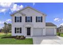 Inviting two-story home with black shutters, well-kept lawn, and attached two-car garage at 64 Cape Point Dr., Conway, SC 29527