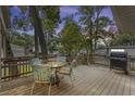 Outdoor deck featuring a table with four chairs and a grill, perfect for relaxing and enjoying the outdoors at 6001-Mh107 S Kings Hwy., Myrtle Beach, SC 29575