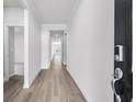 Inviting hallway with wood-look floors, neutral paint, and views into other rooms at 7004 Watercress St, Myrtle Beach, SC 29579