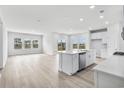 Bright living room featuring an open layout, a kitchen island, and sliding door access to the yard at 7004 Watercress St, Myrtle Beach, SC 29579