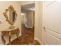Elegant entryway with ornate mirror and console table, showcasing a tiled floor at 100 North Beach Blvd. # 1819, North Myrtle Beach, SC 29582