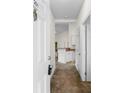 Bright hallway leading to the kitchen, featuring white doors and neutral tones at 1137 Peace Pipe Ln. # 201, Myrtle Beach, SC 29579