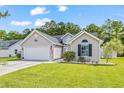 One-story house featuring a gray exterior, two-car garage, and landscaped front yard at 2424 Summerhaven Loop, Conway, SC 29527