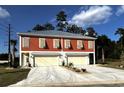 Two-story home with orange siding, two garages, and landscaping at 110 Hallandale Lane # Left, Murrells Inlet, SC 29576