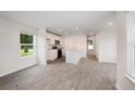 Bright living room with wood-look flooring and an open floor plan into the kitchen at 230 Ashworth Dr., Tabor City, NC 28463