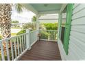 Inviting porch featuring green trim, white rails, and a decorative column at 340 Walden Lake Rd., Conway, SC 29526