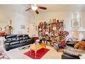 Spacious living room with a vaulted ceiling, ceiling fan, and lots of bookshelves at 719 American Beech St., Loris, SC 29569