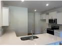 Bright kitchen featuring white cabinets, stainless steel appliances, and a stylish center island at 4753 Huckleberry Ln., Conway, SC 29526