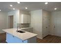Bright kitchen featuring white cabinets, stainless steel appliances, and a stylish center island at 4753 Huckleberry Ln., Conway, SC 29526
