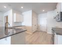 Modern kitchen featuring white cabinets, stainless steel appliances, and a dark granite island at 4753 Huckleberry Ln., Conway, SC 29526