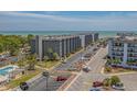 Aerial view showing condo building, parking lot, and ocean at 5905 South Kings Hwy. # A450, Myrtle Beach, SC 29575