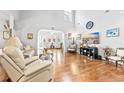 Bright living room with high ceilings, hardwood floors, and a comfortable seating area at 1296 Foxtail Dr., Longs, SC 29568
