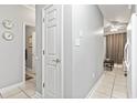 Clean hallway with white door and tiled floor at 1525 Lanterns Rest Rd. # 103, Myrtle Beach, SC 29579