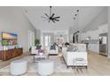 Bright open living room featuring vaulted ceilings, modern furnishings, and hardwood floors at 205 Waterfall Circle, Little River, SC 29566