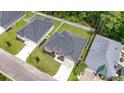 Aerial view of a well-maintained residential neighborhood with manicured lawns and mature trees, featuring a brick home at 297 Waterfall Circle, Little River, SC 29566