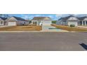 Attractive single-Gathering home featuring white siding, a two-car garage, and a well-manicured front lawn at 329 Palmetto Sand Loop, Conway, SC 29527