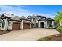 Elegant home featuring a cobblestone drive, three-car garage, and a sophisticated dark trim design at 372 Chamberlin Rd., Myrtle Beach, SC 29588