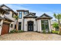 Grand front entrance showcasing an arched doorway, a brick facade, and professionally landscaped greenery at 372 Chamberlin Rd., Myrtle Beach, SC 29588