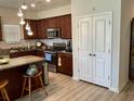 Well-equipped kitchen with stainless steel appliances and dark wood cabinets, including a kitchen island at 408 Stevia Ct., Conway, SC 29526