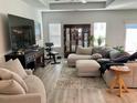 Bright and airy living room with comfortable seating and ample natural light. Tray ceiling overhead at 408 Stevia Ct., Conway, SC 29526
