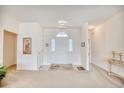 Spacious foyer with neutral walls and carpet, features an arched entryway and elegant lighting at 812 Lalton Dr., Conway, SC 29526