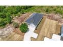 Aerial view showcasing the home's layout, landscaping, and driveway at 7913 E Highway 19, Loris, SC 29569