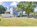 Charming blue two-story home with a fenced yard and a covered parking area in the rear at 4162 Mica Ave., Little River, SC 29566