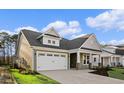 Attractive curb appeal with landscaped yard, two car garage, and inviting entrance at 5032 Cambria Ct., Little River, SC 29566