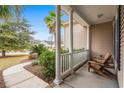 Inviting front porch view features classic columns and outdoor seating at 621 Elgin Ct., Myrtle Beach, SC 29579