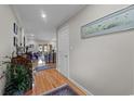 Elegant hallway with hardwood floors, crown molding, and doorway leading to a living room at 1562 Hawthorn Dr., Pawleys Island, SC 29585