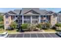 Condo building exterior with landscaping and parking at 4633 Lightkeepers Way # 5-J, Little River, SC 29566