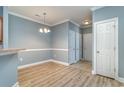 Dining area featuring modern flooring, wainscoting, and access to the entryway at 2073 Silver Crest Dr. # 4 D, Myrtle Beach, SC 29579