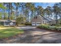 Exterior view of brick home and two-car garage with ample parking space at 2807 Graham Rd., Conway, SC 29526