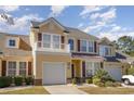Inviting yellow home boasts a private balcony, manicured lawn and attached garage at 206 Mossy Stone Ct. # 1605, Murrells Inlet, SC 29576
