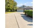 Long driveway leads to a home with an attached two-car garage, offering ample parking and curb appeal at 1664 Randor Ct., Myrtle Beach, SC 29579