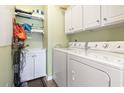 Efficient laundry room featuring a washer, dryer, sink, and shelving for organized storage at 1664 Randor Ct., Myrtle Beach, SC 29579