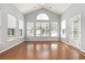 Bright sun room with hardwood floors, large windows, and a vaulted ceiling, offering ample natural light at 323 Trestle Way, Conway, SC 29526