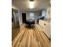 Bright kitchen featuring stainless steel appliances, white cabinets, modern lighting and a black door at 416 S Magnolia Ave., Andrews, SC 29510